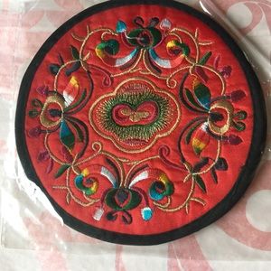 A pair of embroidered round coaster